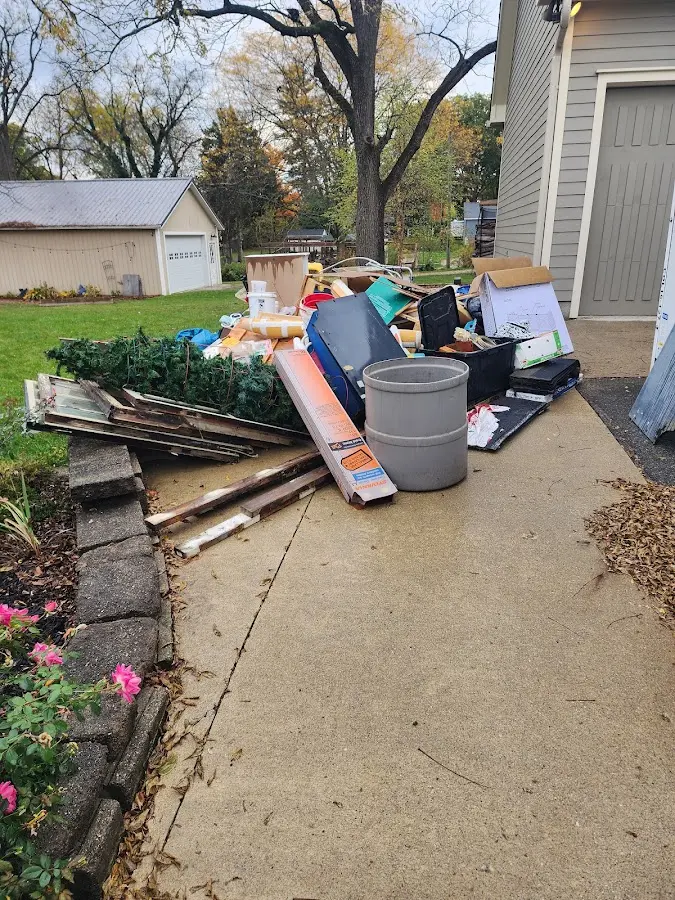 Dumpster being loaded with debris for 3 Yard Dumpster Rental in Addison